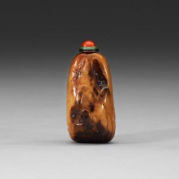 55. A soapstone snuff bottle with a carved landscape and a nine-character inscription, late Qing dynasty (1644-1912).