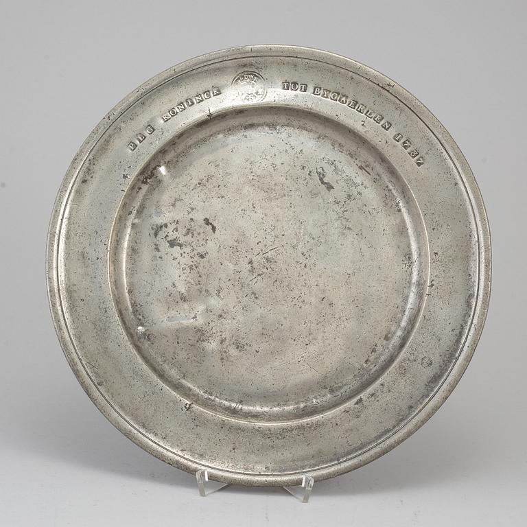 A pewter plate, dated 1787.