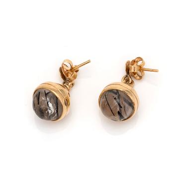 A pair of earrings with cabochon-cut rutilated quartz.