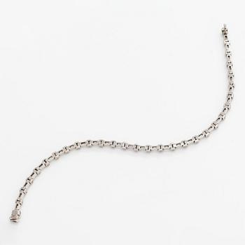 An 18K white gold bracelet set with baguette and brilliant-cut diamonds.