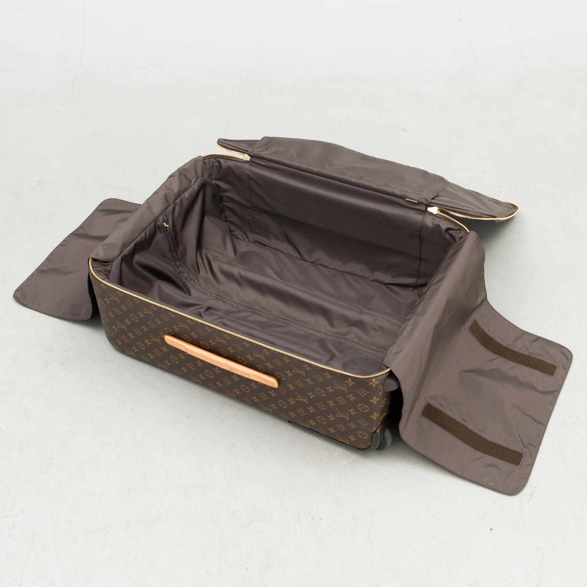 A Monogram Canvas Pégase 65 Suitcase with a Protective Cover.