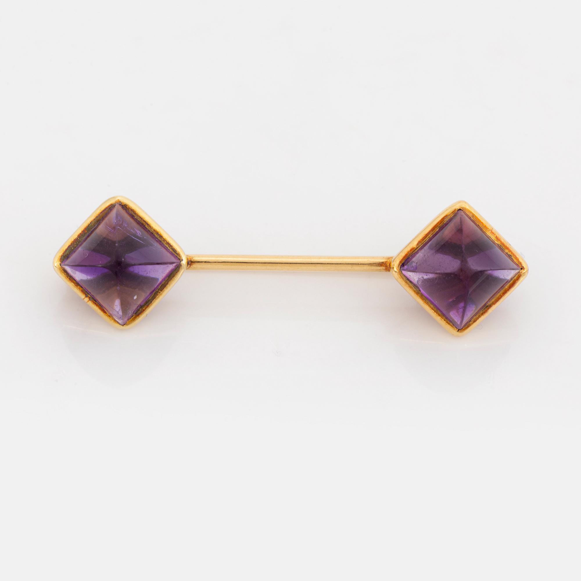 Brooch and earrings with cabochon cut amethysts.