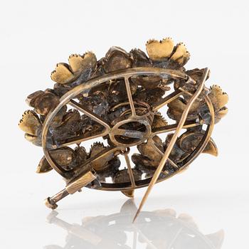 A brooch flower with rose-cut diamonds.