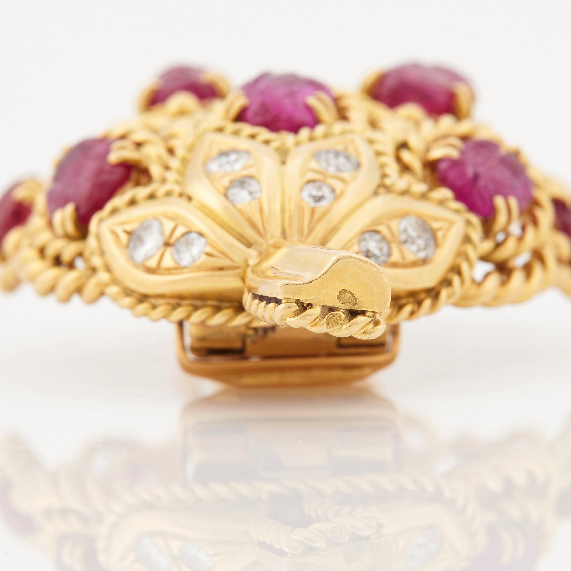A 1950/60's brooch by Cartier, in the shape of a strawberry, set with carved rubies and brilliant cut diamonds.