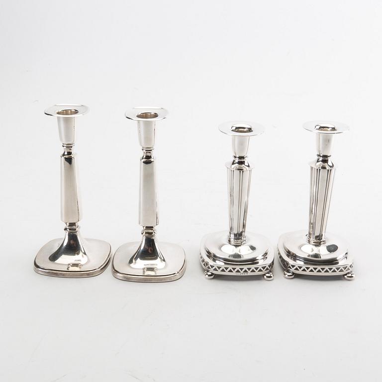 Two pairs of silver candle sticks from 1956 and 1992.