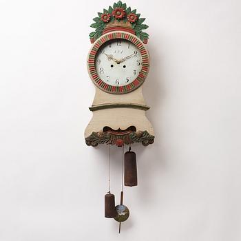 a painted wall pendulum clock from Ångermanland in the first half of the 19th century.