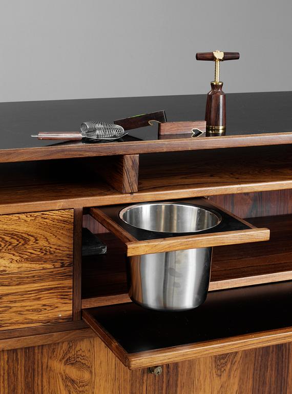 A Danish palisander bar by Dyrlund Smith, 1960´s, with four stools, marked AB COCKTAIL MÖBLER.