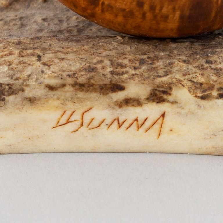 Lars Levi Sunna, a grouse reindeer horn and birch figurine, signed LL Sunna.