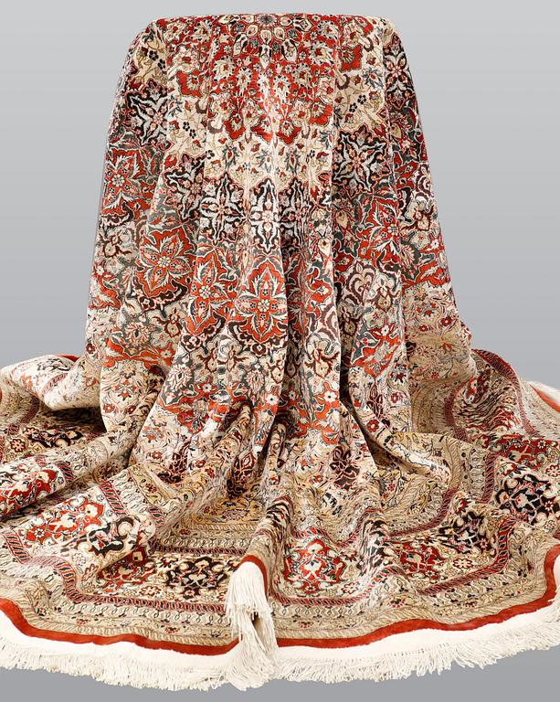An Oriental silk rug, diameter 256 cm.