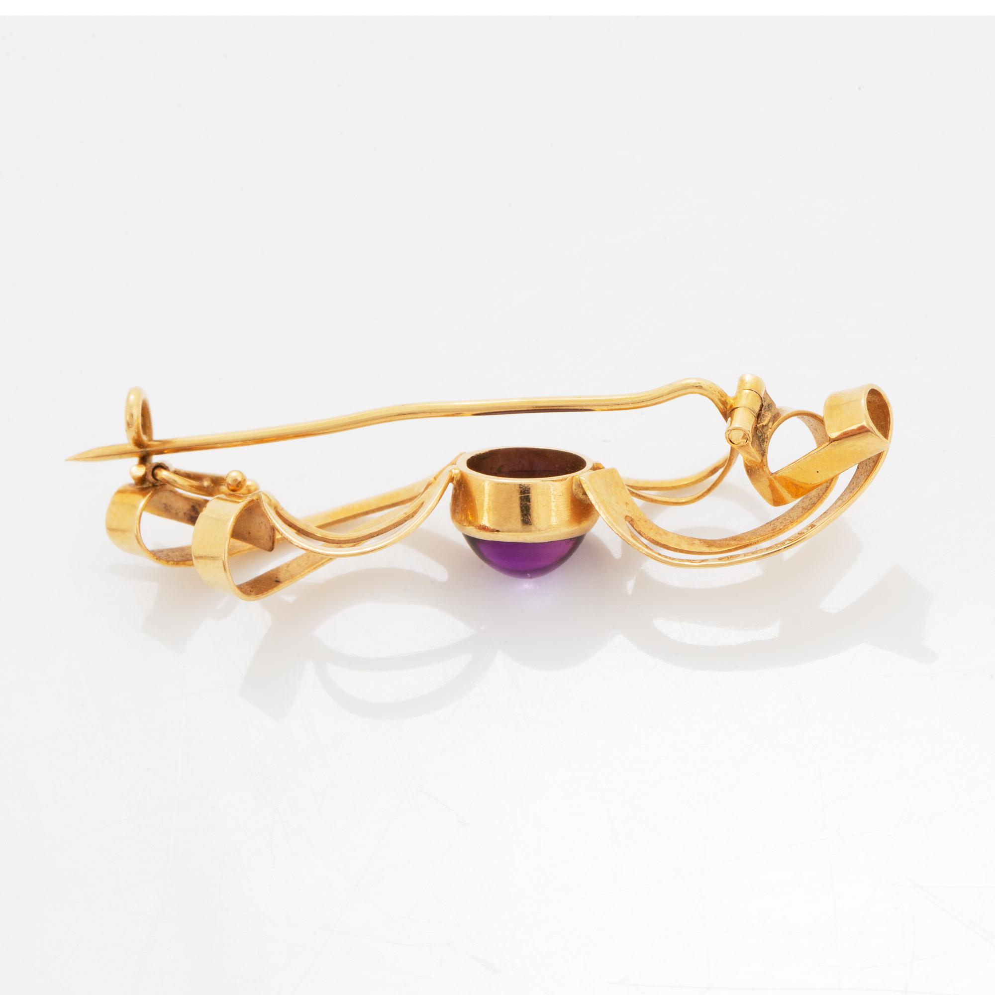 A pair of earrings and a brooch.