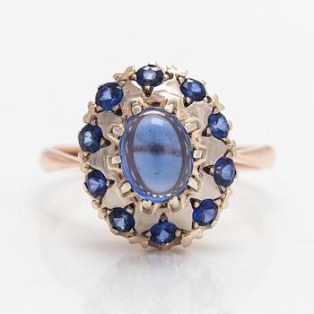 A 14K gold ring with a cabochon-cut synthetic sapphire and real sapphires. Yerevan.