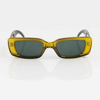 Gucci, a pair of yellow sunglasses.