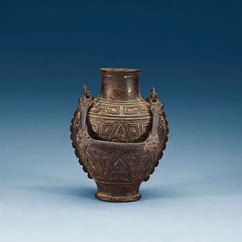 An archaistic bronze vase with a handle, presumably Ming dynasty.