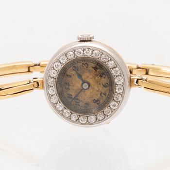 An 18K white and red gold watch set with round old cut diamonds.