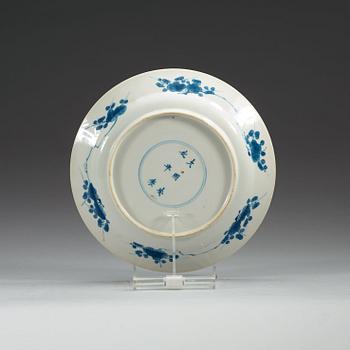 A set of four odd blue and white dinner plates, Qing dynasty, Kangxi (1662-1722), with different six character marks.