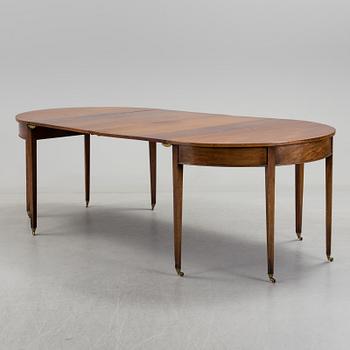 A English George III dining table veneerde with mahogany with two extension leafs from the late 18th century.