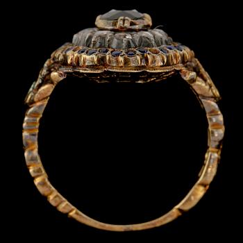 RING, 18k guld med 12 fasettslipade diamanter samt blå safirer, Gustav Dahlgren & Co, Malmö, 1939.