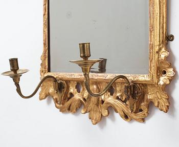 A pair of Rococo 18th century two-light girandole mirrors.