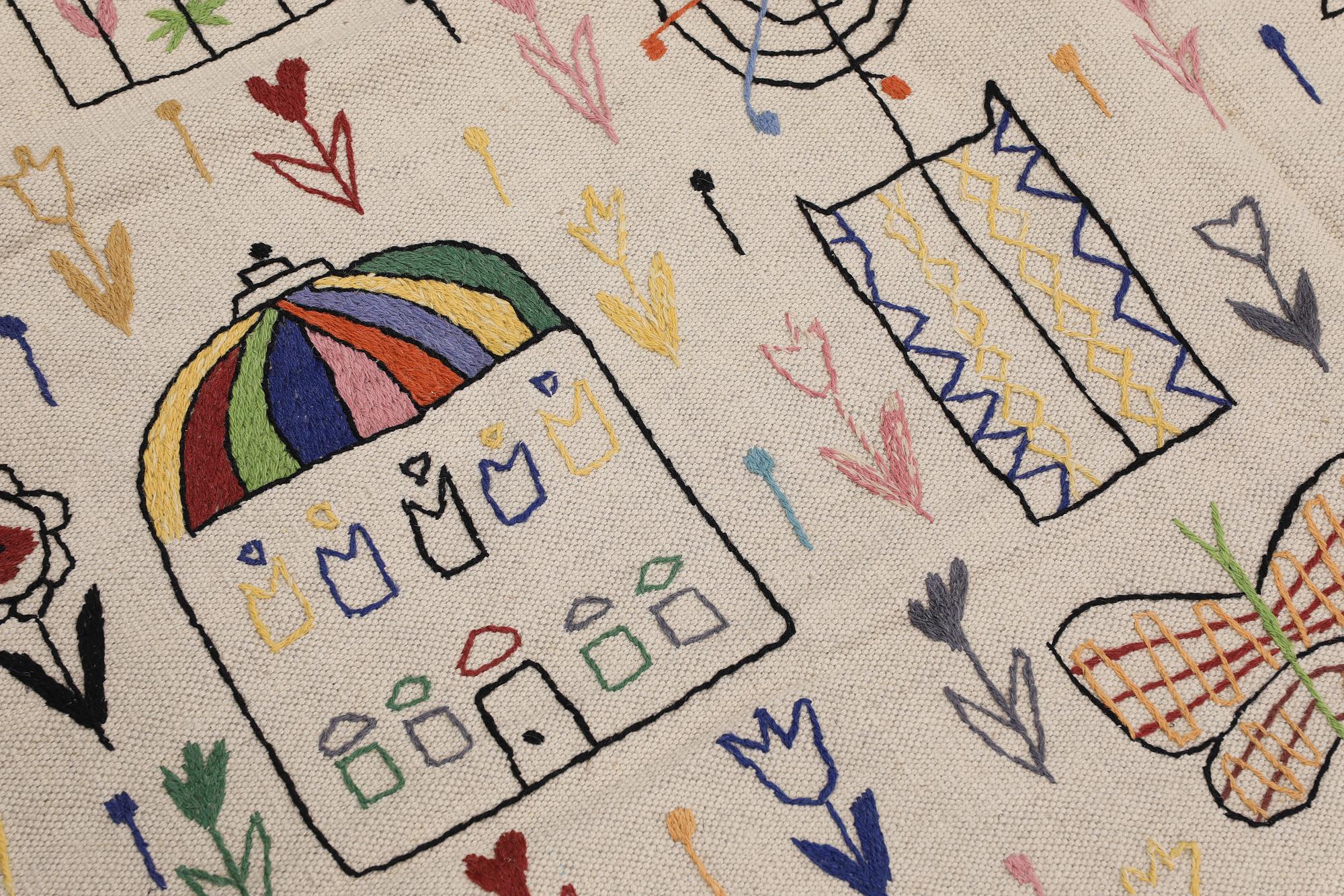 A Kilim carpet with hand-embroidered decoration, 239 x 182 cm.