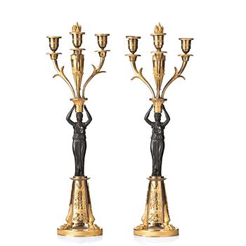 122. A pair of French Empire early 19th century three-light candelabra.