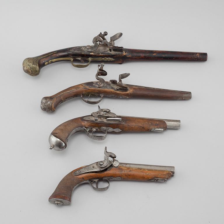 Four percussion and flintlock revolvers from the late 18th century / 19th century.