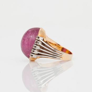 A cabochon-cut tourmaline and brilliant-cut diamond ring.