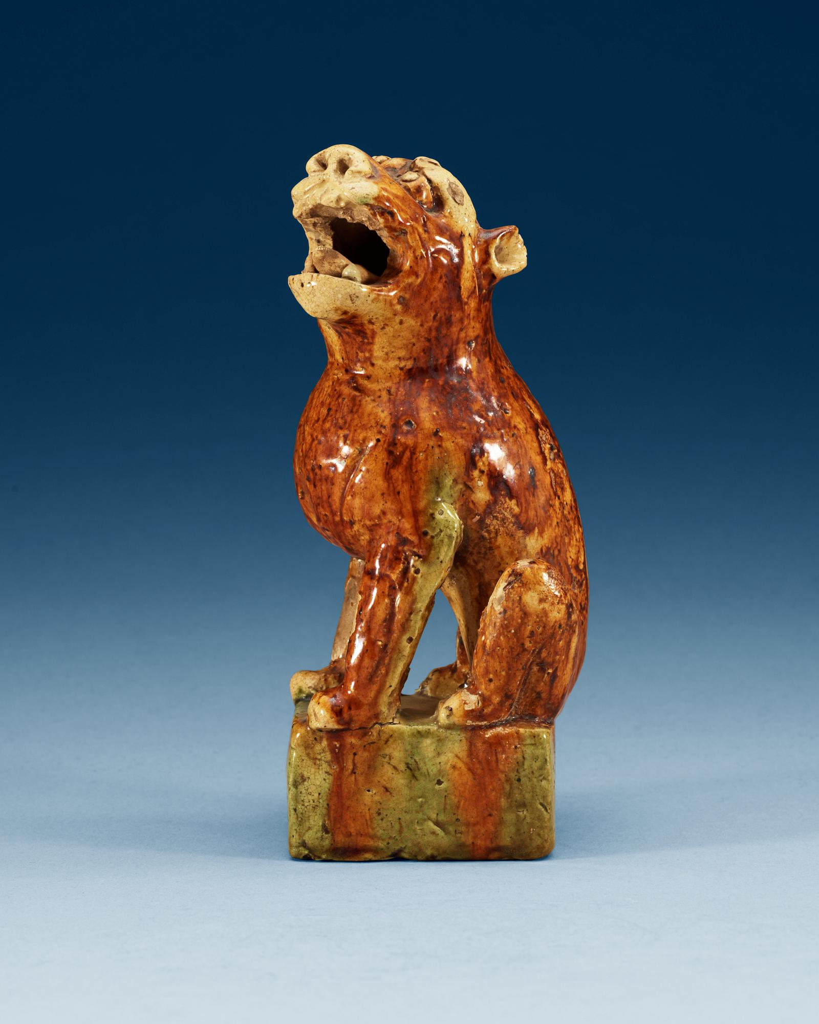A potted figure of a 'Buddhist Lion', Tang dynasty (618-907).