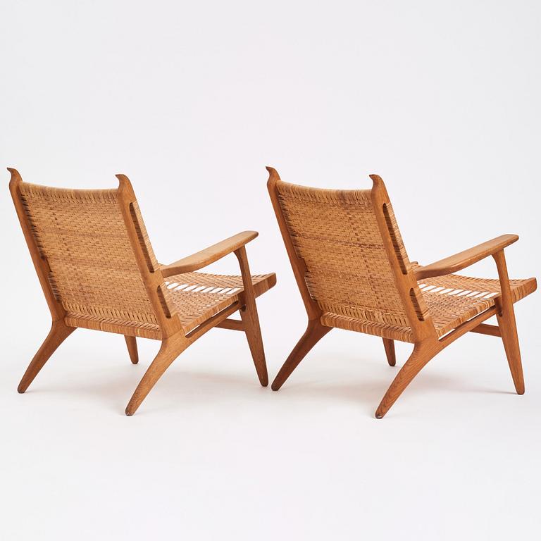 Hans J. Wegner, a pair of oak easy chairs 'CH27', Carl Hansen & Son, Denmark, 1950s.