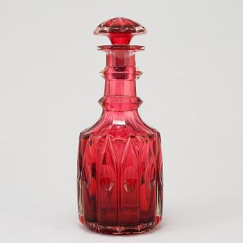 A MID 19TH CENTURY RED GLASS DECANTER AND STOPPER.