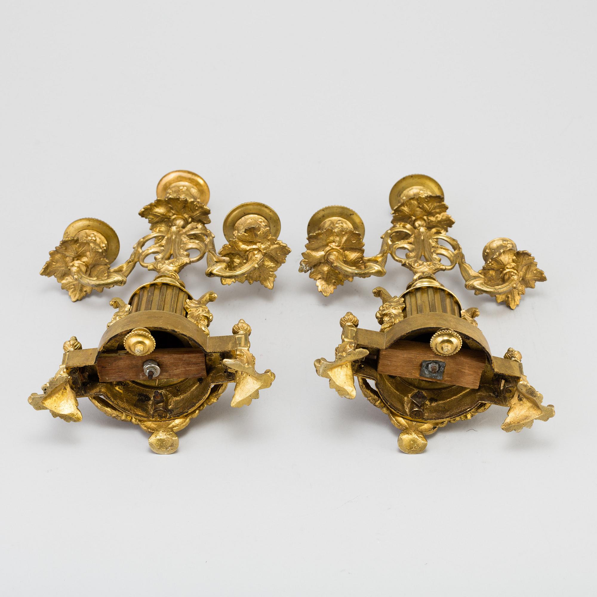 A table CLOCK and a pair of candelabra, second part of 19th century.