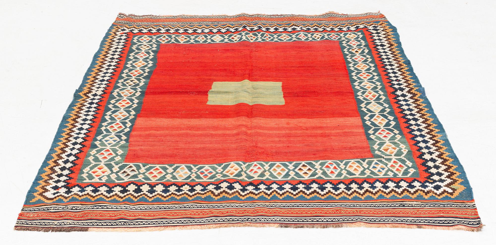 An antique Qashqai kilim rug, approximately 240 x 155 cm.