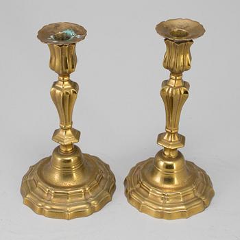 A pair of 18th century bronze candlesticks.