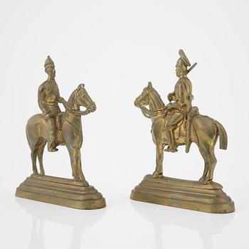 A pair of brass book stands,