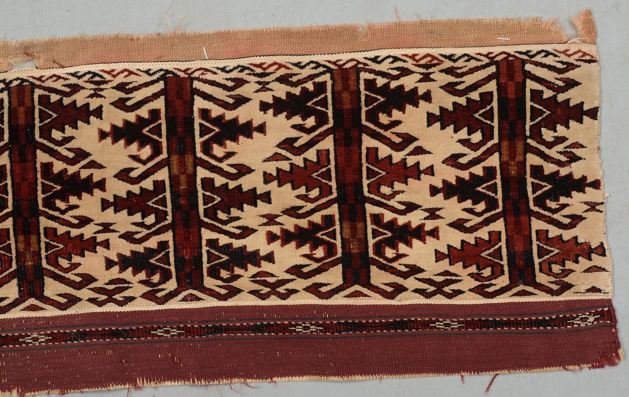 ANTIQUE TURKMEN FRAGMENT. Probably fragment of a kapunuk or a jollar. 24 x 130 cm.