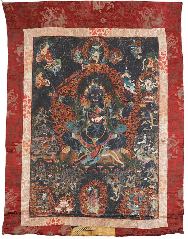 A Tibetan Thangka of Mahakala surrounded by fierce Dharma protectors, 19th century.