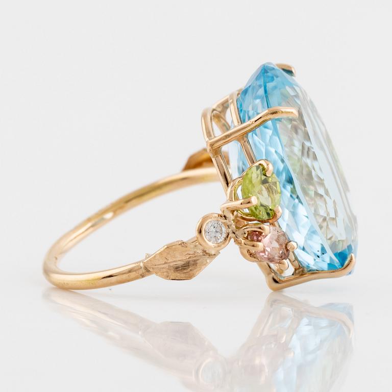 Large blue topaz, peridot, pink tourmalines and brilliant cut diamond cocktail ring.