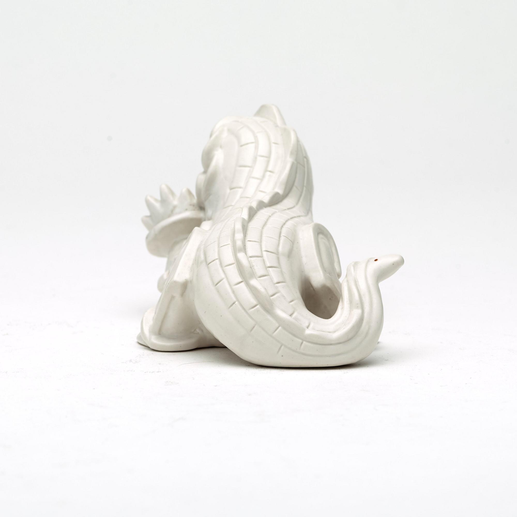 Wilhelm Kåge, a set of stoneware figures of a 'dragon puppy' and two 'dragon puppies' with candle holders, Gustavsberg, ca 1940.