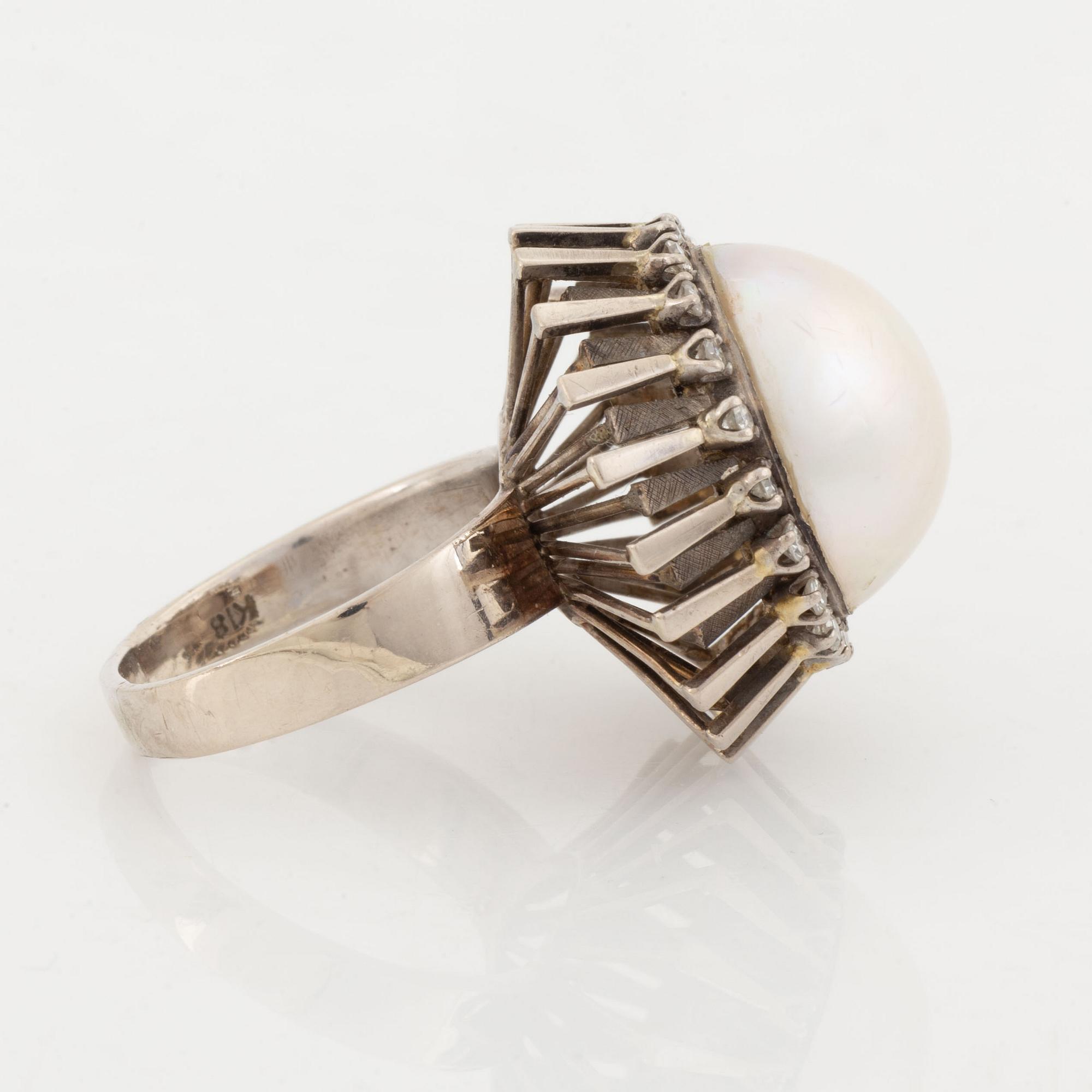 A pearl and diamond ring.