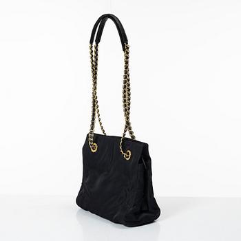 Prada, A black nylon bag.