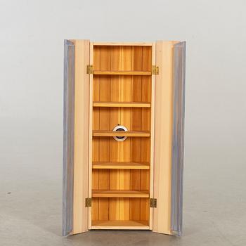 A wall cabinet "Blå ljus" design Olof Pira.