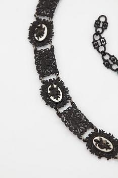 A Berlin steel and iron parure comprising a necklace, two bracelets and a brooch.