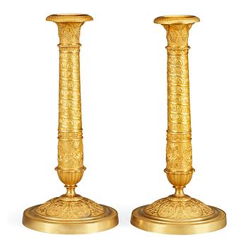 627. A pair of French Empire early 19th century candlesticks.
