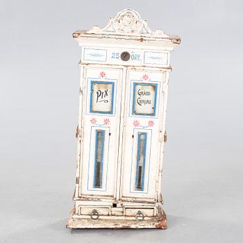 A circa turn of the century candy dispenser.