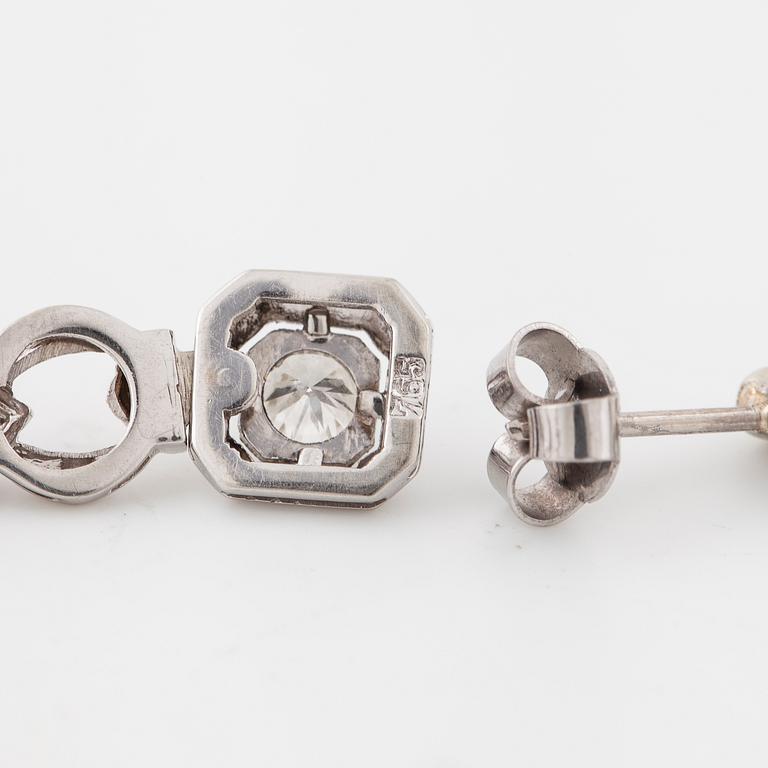 A pair of brilliant cut diamod earrings.