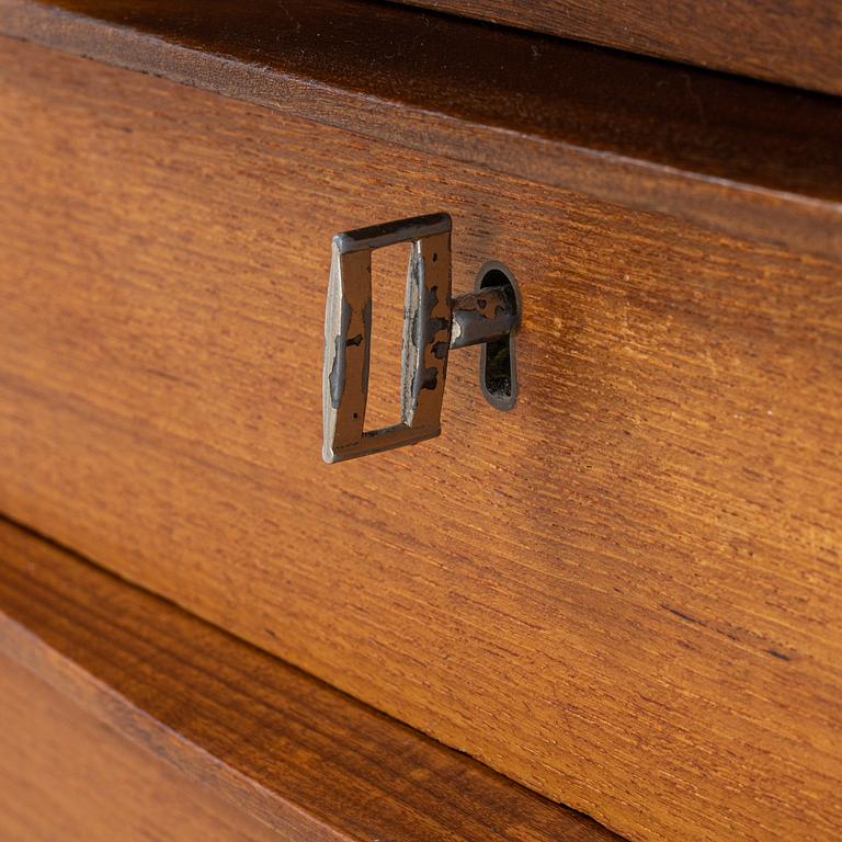 A teak veneered writing desk, 1960s.