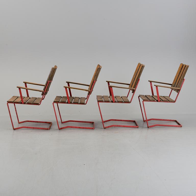 A garden table and four chairs, 20th century.