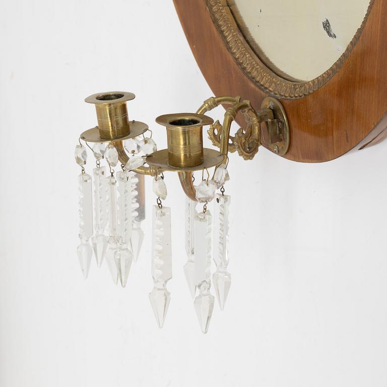 A mahogany veneered mirror sconce, Empire style, around 1900.