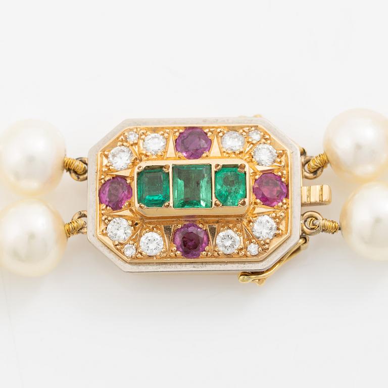 Pearl necklace, two-stranded, with a clasp by Seblings in 18K gold set with emeralds, rubies, and brilliant-cut diamonds.