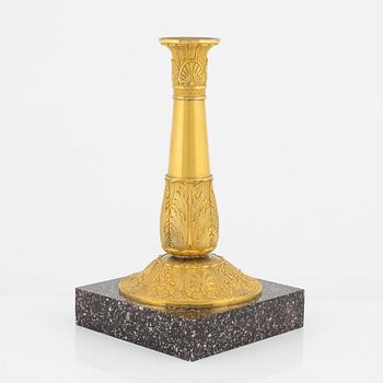 A bronze and porphyry candlestick, 20th Century.