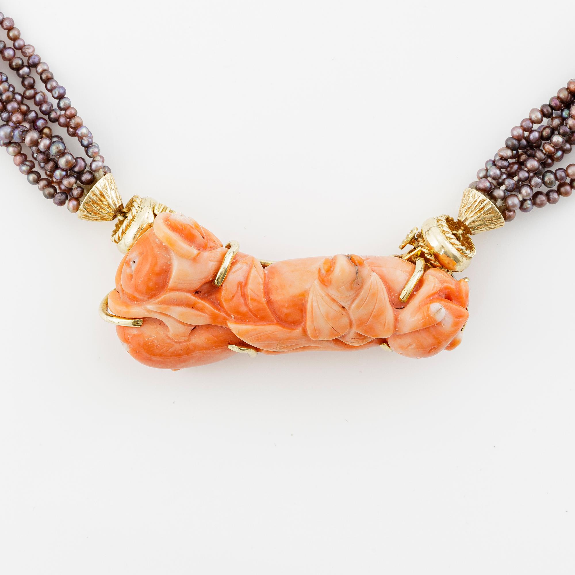 Multi-strand pearl necklace with two clasps set with carved coral, cabochon-cut tourmaline, and brilliant-cut diamonds.